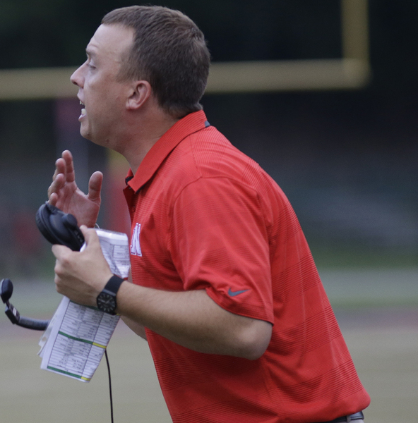 Newport head coach Matthew Schmitz gives instuctions  during their football game, Friday, Aug. 30,2014. 