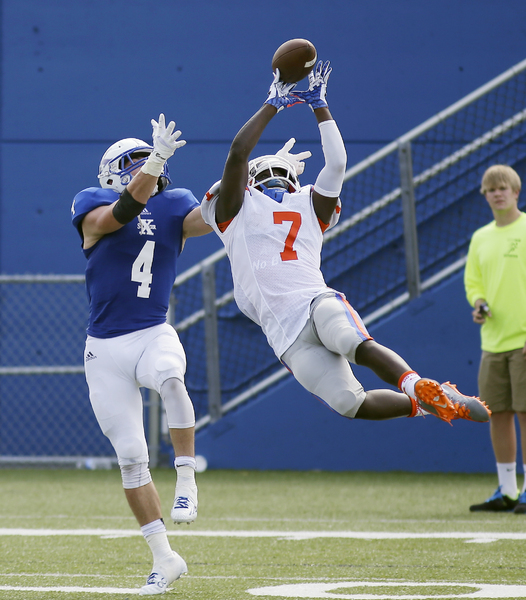 East St. Louis defensive back Kendell Poe(7) breaks up a pass intended for St. Xavier's Ben Glines . 