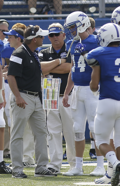 St. Xavier head coach Steve Specht talks with qb Sean Clifford. 