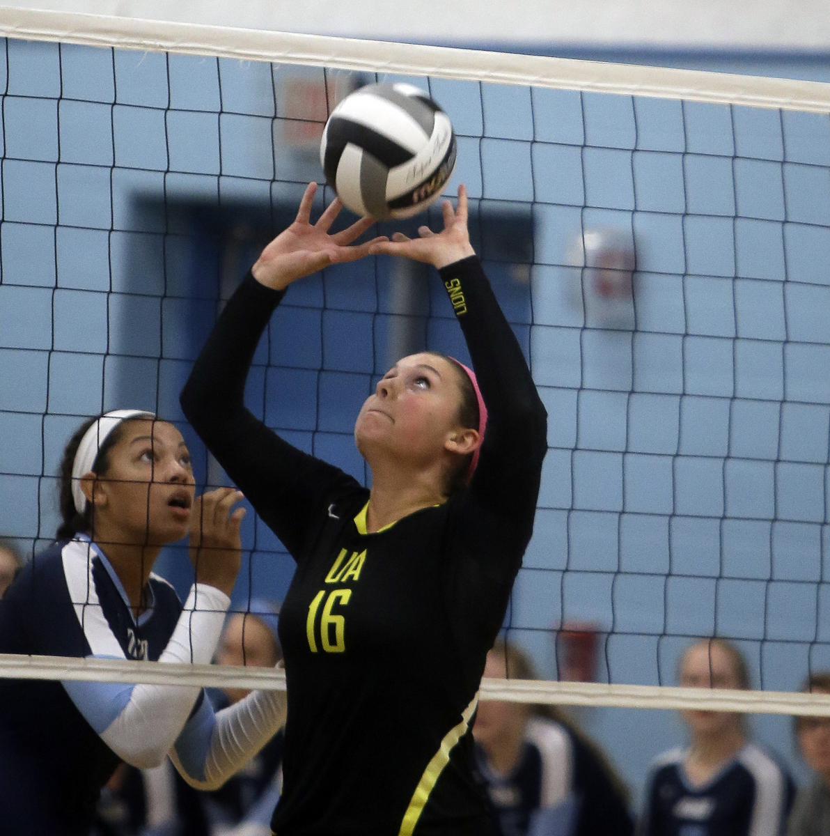 Ursuline's  Anne Debbane sets up a teamate  during the the Lions volleyball game against Mount Notre Dame,