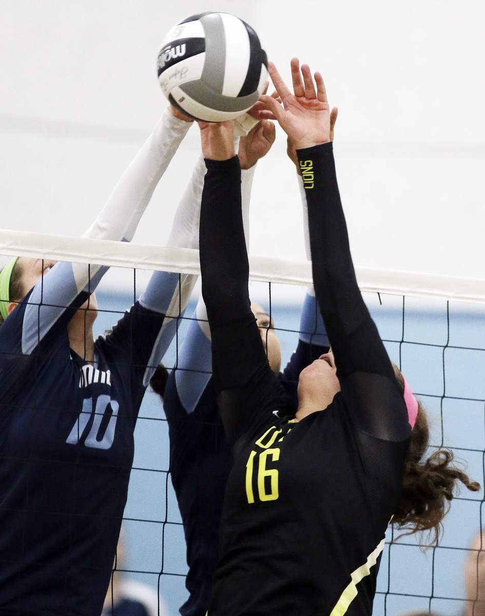  Anne  Debbane (16) Ursuline and  Mount Notre Dame's Dani  Szczepanski meet at the net  during the their volleyball game, 