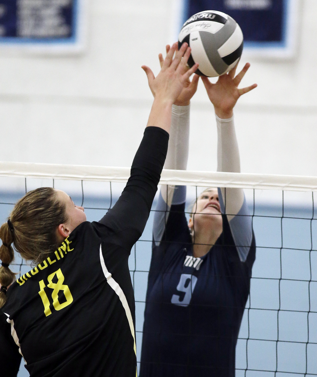 Mount Notre Dame's Christine Carroll(9) stops a kill attempt by Ursuline's Maggie Shannon.
