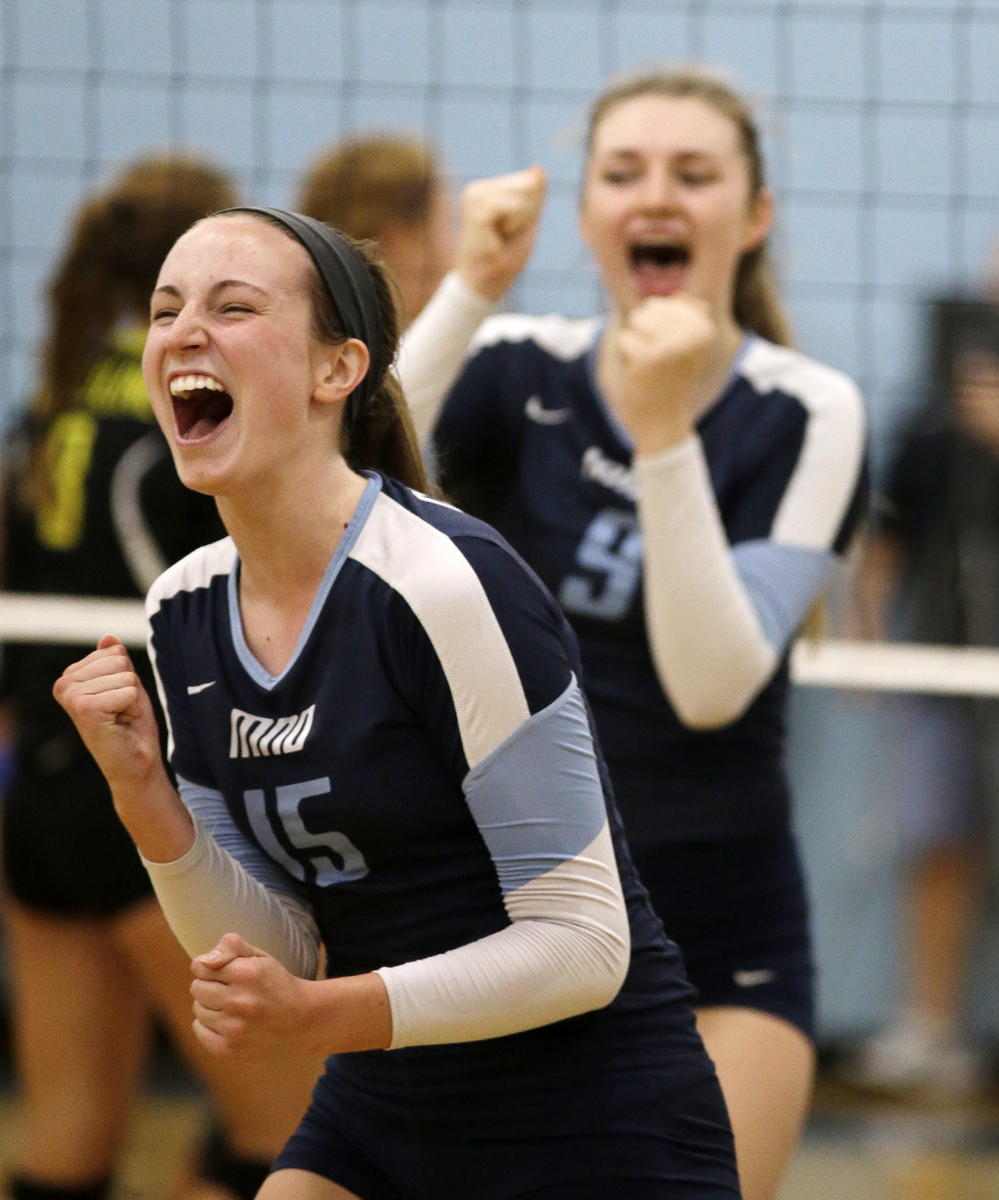 Mount Notre Dame's Jessica Towle(15)and Christine Carroll celebrate during the Cougars volleyball game against Ursuline