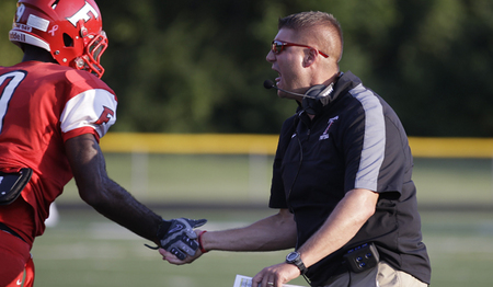 Fairfield head coach Jason Krause celebrates with his players.