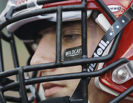 Newport's Brian Burton listens to the referee before the Wildcats football game against Walton Verona. 