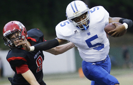 Walton Verona running back William Latimore runs away from Newport's Ryan Ochoa during their football game, Friday, Aug. 30,2014. 