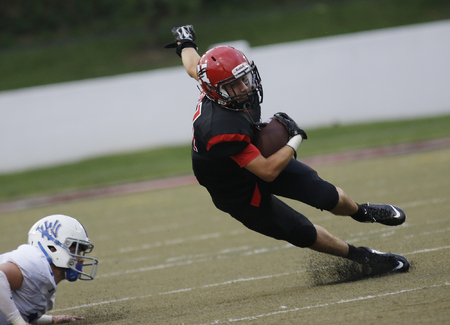  Newport's Brian Burton is tripped up by a Walton defender  the  during their football game, Friday, Aug. 30,2014.