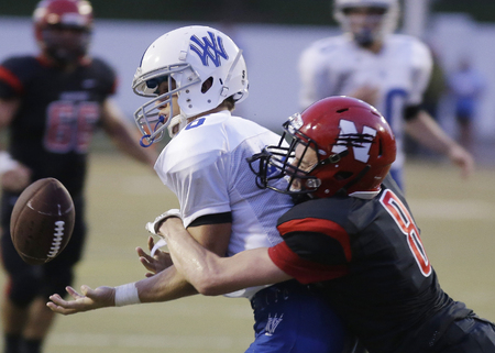 Newport's Ryan Ochoa(8) breaks up a pass intended for Walton Verona's  Mason Compton  during their football game, Friday, Aug. 30,2014.