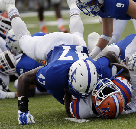 St. Xavier linebacker Justin Hillard(47) tackles East St. Louis running back Marvin Young