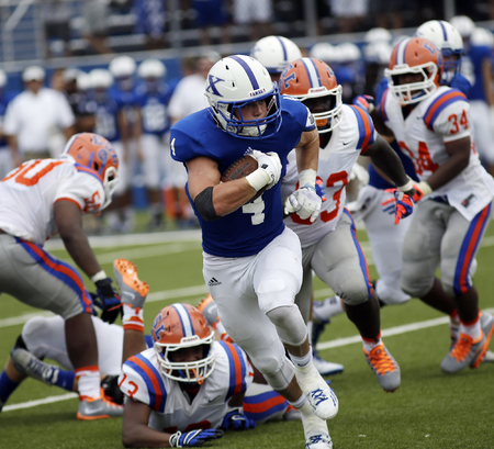 St. Xavier running back Ben Glines runs the ball for the Bombers during their football game against East  St. Louis