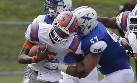 St. Xavier's Billy McConnell (57) tackles East St. Louis qb  Estes  Reyondous