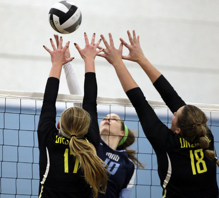 Mount Notre Dame's Dani  Szczepanski (10)  tries to get the ball past Ursuline's  Malllory Bechtold and Maggie Shannon during the their volleyball game